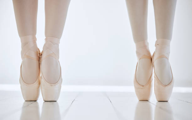 istock Ballet, shoes and feet on pointe, flexibility and strong performance or exercise, training and fitness. Legs, people and active in dance studio, dancers and ballerinas or workout, together and cardio 1816125757