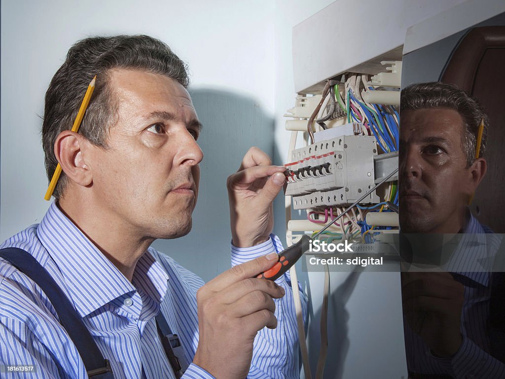 electrician at work electrician works with wires Adult Stock Photo