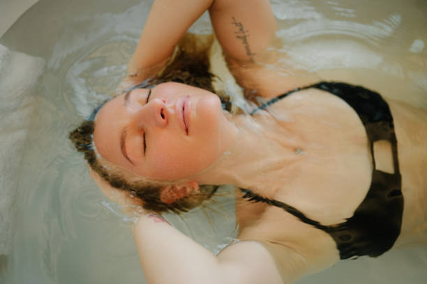 istock Sensual model enjoying spa routine at evening bathroom 1816148318