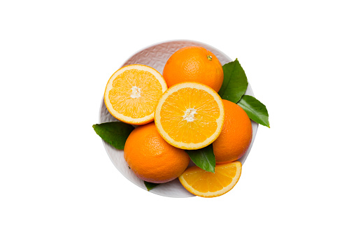 Flat lay of Fresh orange fruit with sliced in plate isolated on white background. Top view with copy space.