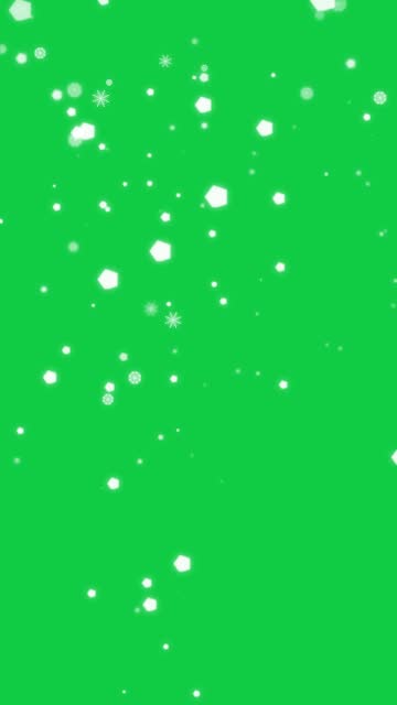 particle animation of white snowflake falling down isolated on green screen background
