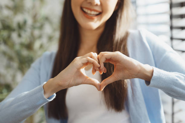 istock Focus on young woman's hands making heart sign with her hands 1816163014