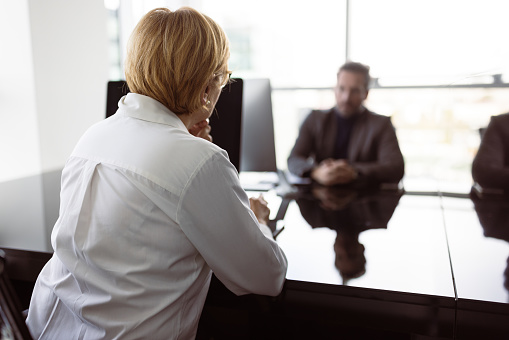 Businessman on job interview. Shallow DOF, focus on woman in foreground