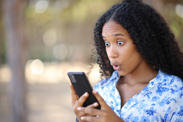 istock Amazed black woman checking content on phone 1816190747