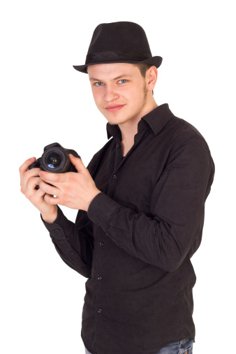 Professional photographer holding camera and smiling