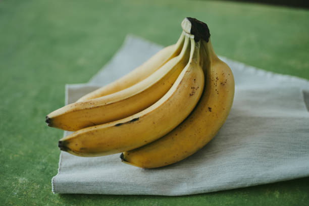 istock Close-up of bananas on green background 1816210320