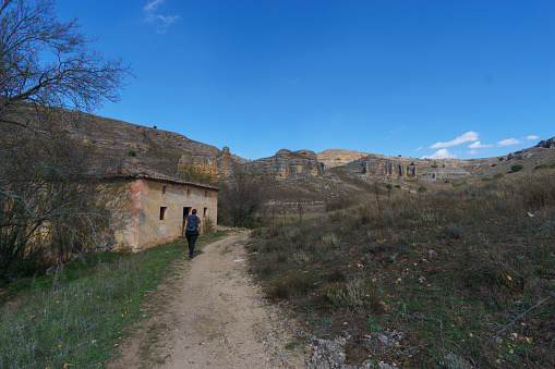Hiking path with woman in the Hoces del Duraton natural park near Sepulveda, Segovia, Spain