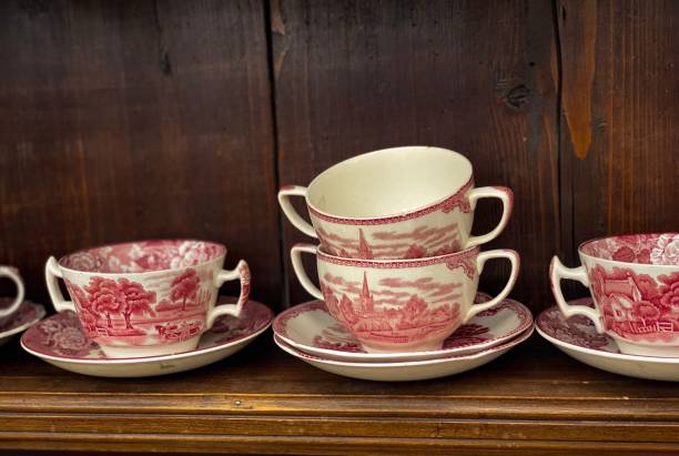 istock Array of delicate porcelain teacups and saucers displayed on a wooden shelf 1816222080