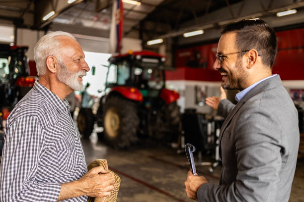 istock Dealer and farmer in tractor workshop talking about service and maintenance. 1816233879