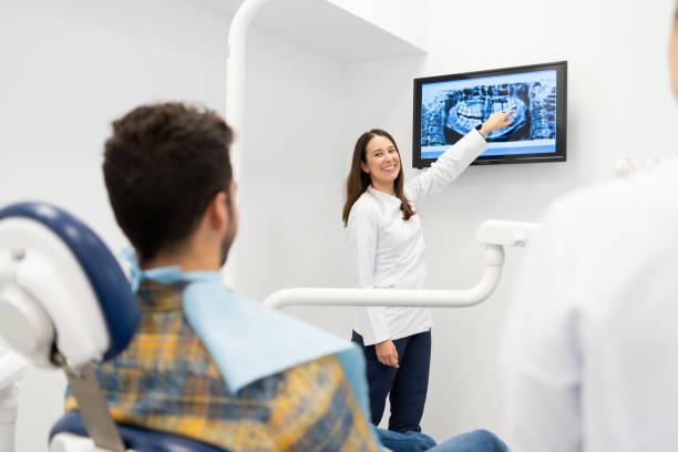 istock Dentist showing the results of a X-ray scan 1816238152