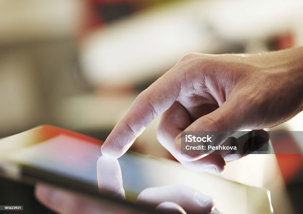Close up of man's hand poring on tablet device High resolution businessman holding digital tablet Close-up Stock Photo