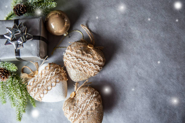 istock Christmas background frame with fir branches, pine cones, siver gift box and heart shaped decorations. New year grey color banner with copy space for text 1816240290
