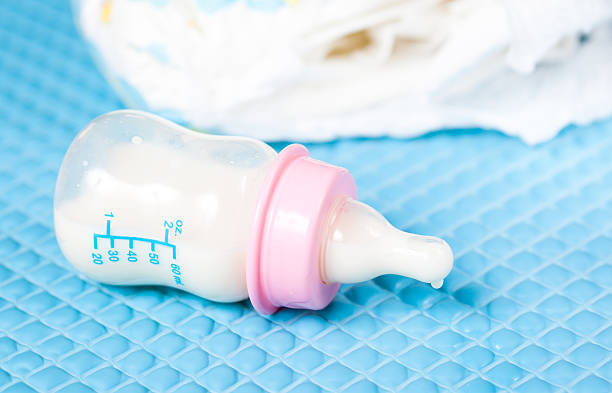 istock Baby bottle on a blue Rubber apron 181624261