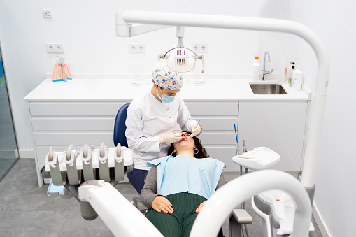 Elevated view of cleaning treatment for a woman in a dental clinic