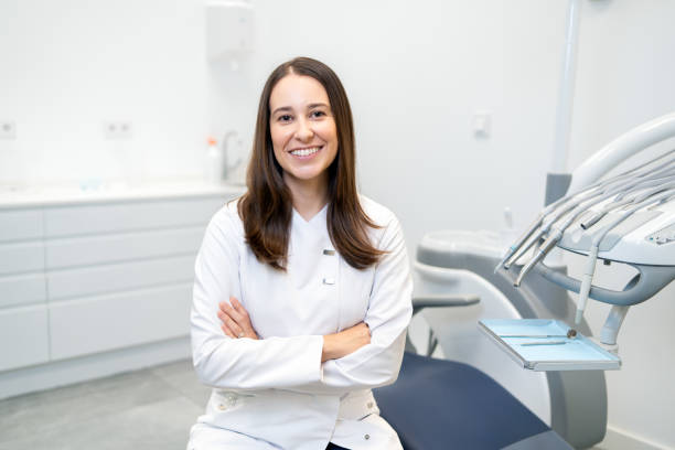 istock Dentist smiling at camera sitting on a dental clinic 1816248979