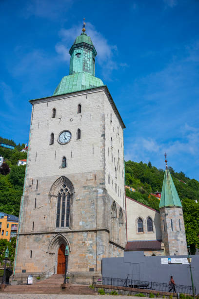bergen cathedral in the city of bergen, norway is illumnated by a summer sunset - scandinavian church front view norway imagens e fotografias de stock