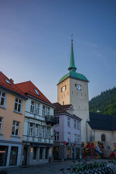 bergen cathedral in the city of bergen, norway is illumnated by a summer sunset - scandinavian church front view norway imagens e fotografias de stock