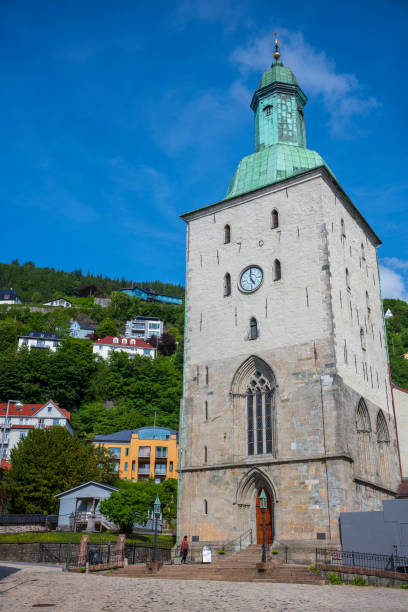 bergen cathedral in the city of bergen, norway is illumnated by a summer sunset - scandinavian church front view norway imagens e fotografias de stock