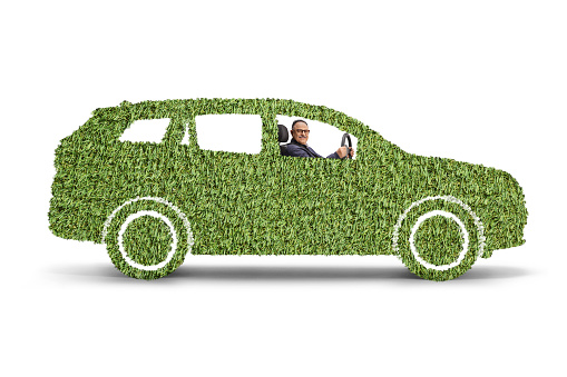 Man riding a green electric car, sustainable mobility isolated on white background