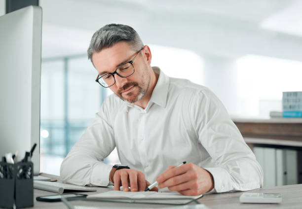 istock Businessman, writing and planning in notebook, notes and research for vision, strategy and information. Mature business person, journal and brainstorming for future company growth, schedule or agenda 1816261579