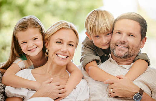 Family, smile and hug on couch, portrait and bonding at home, fun and embrace for love. Parents and children, connection and security in relationship, happy and care or relaxing, living room and sofa