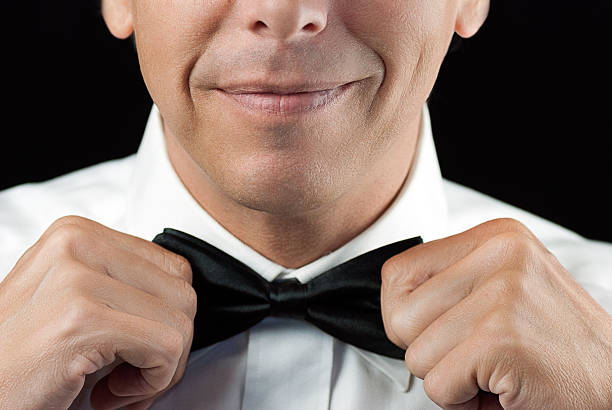 istock Man In Tux Straightens Bowtie, Two Hands 181627219