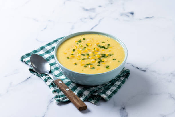 istock Corn soup in green bowl on wooden table. Close up 1816275035
