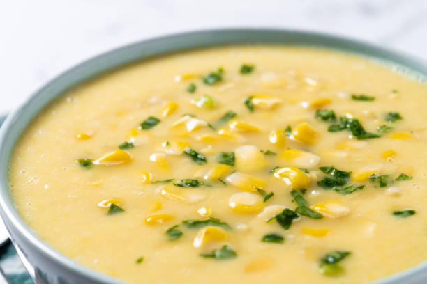 istock Corn soup in green bowl on wooden table. Close up 1816275056