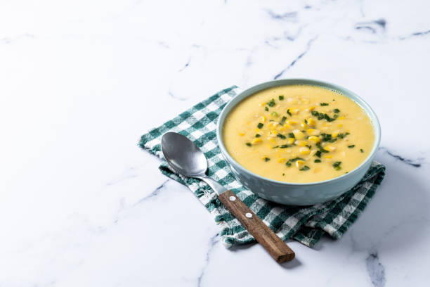 istock Corn soup in green bowl on wooden table. Close up 1816275572