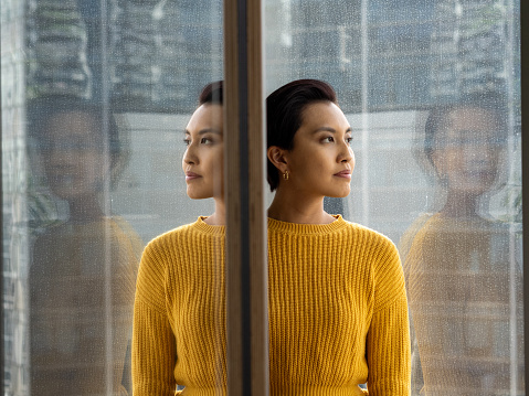 Business People - Portrait of a beautiful Asian Chinese female in yellow cardigan