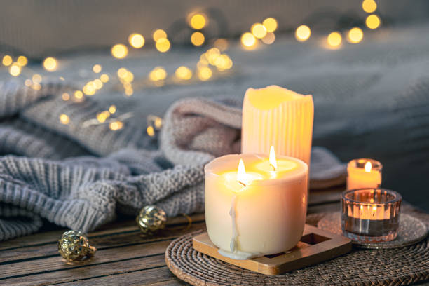 istock Cozy background with burning candles and knitted element. 1816290001