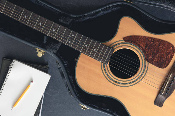 istock Acoustic guitar and notepad with pencil, top view. 1816292786