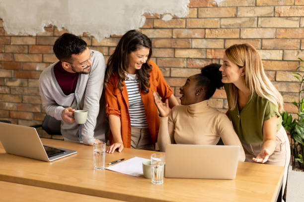 istock Young multiethnic startup team working by the brick wall in the industrial style office 1816293312