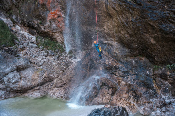 istock Person Rappelling Down Waterfall at Canyoning Adventure 1816298183