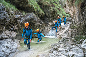 Diverse Canyoning Participants in Motion
