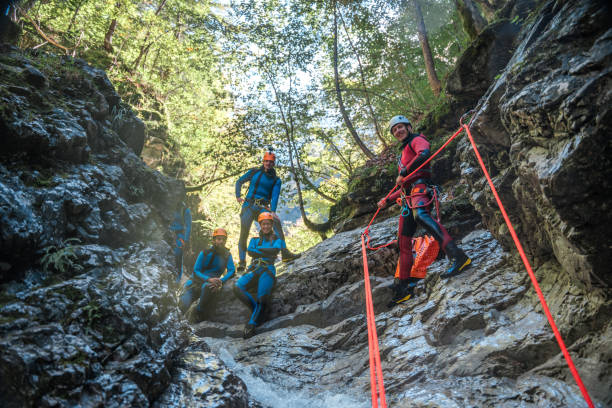 istock Diverse Group with Caucasian Canyonig Guide and Rappel Gear 1816298223