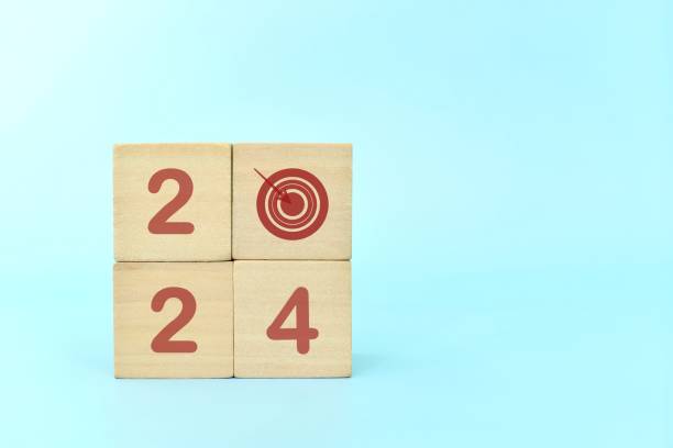 istock Year 2024 business target concept. Human hand stacking wooden blocks with 2024 target icon. 1816305886