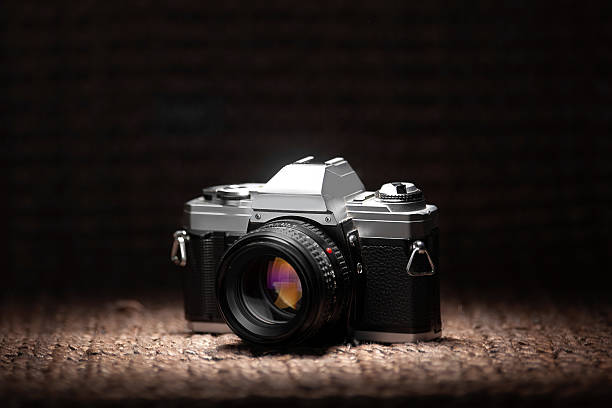 istock Old 35mm film camera under a spot light 181631623