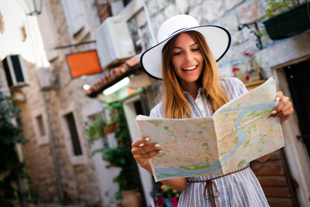 istock Young female tourist with map looking for a way on summer vacation 1816318882