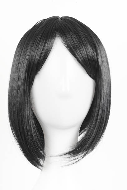 istock Natural looking black wig on white mannequin head. Medium length straight hair with bangs on the metal wig holder isolated on white background, front view 1816330821