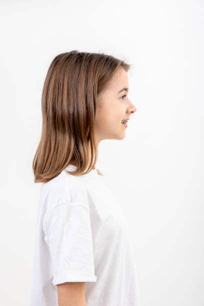 istock Brunette girl smiling with braces on her teeth on a white background isolated. 1816355103