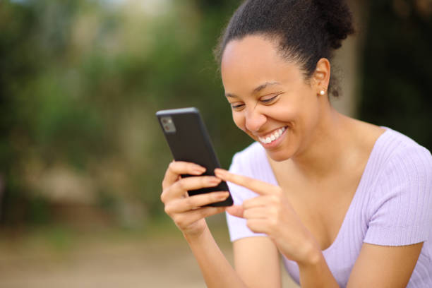 istock Happy black woman checking smart phone 1816355637