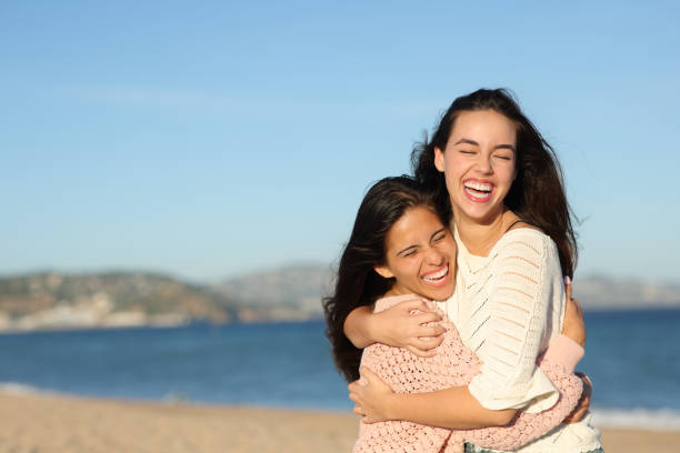istock Two funny friends hugging on the beach 1816358824