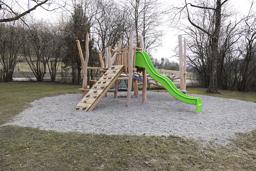 A shot of four empty swings on a sunny winters day.