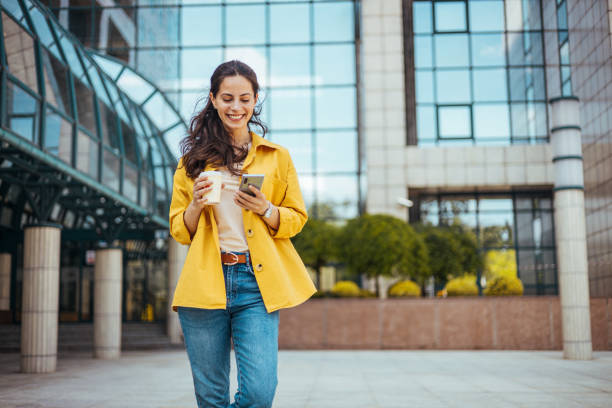 istock Girl using mobile phone on a city street. 1816362515