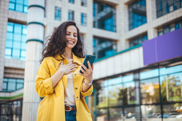 istock Girl using mobile phone on a city street. 1816363576
