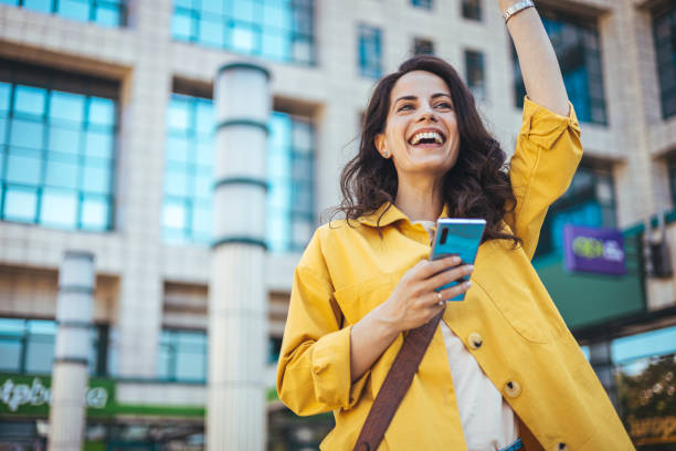 istock Beautiful happy young woman messaging on smartphone 1816366252
