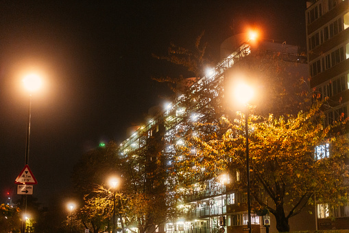 Exterior architecture of an apartment building illuminated at night in central London, UK.