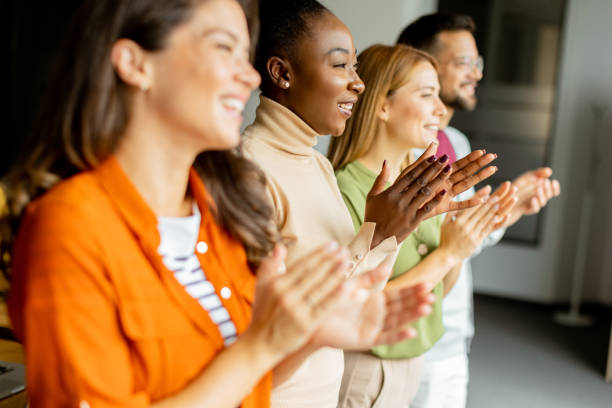 istock Young multiethnic startup team standing and applauding in the modern office 1816370441