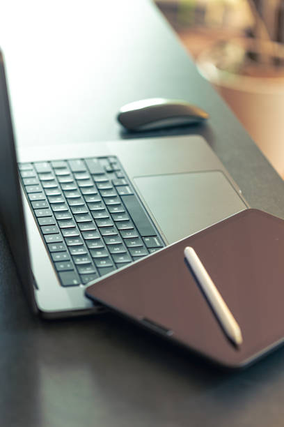 istock Digital tablet, stylus pen and laptop on the desktop, close up. 1816370459